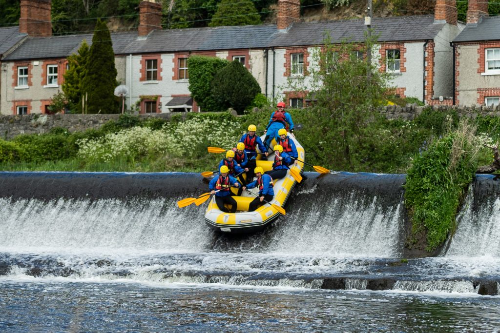 Stag group rafting over a weir near Dublin