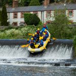 Stag group rafting over a weir near Dublin