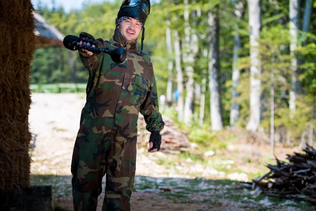 Players in paintball prepare for fight