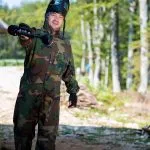 Players in paintball prepare for fight
