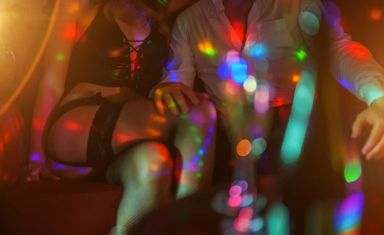 Man and stripper dancer in strip club.